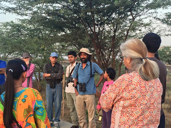 2015-6-6 Vijay in action introducing the concepts of native species and the ecosystem they support, a representative of the first 10 minute orientation of most walks